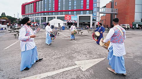 Fans play drums outside Old Trafford cricket ground after fifth and final Test match between England and India was called off. (Photo | AP)