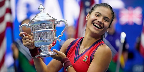 Emma Raducanu holds up the US Open trophy after defeating Leylah Fernandez during the women's singles final of the US Open tennis championships in New York. (Photo | AP)