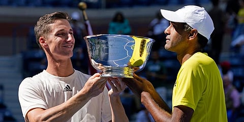 Joe Salisbury (L) and Rajeev Ram hold their men's doubles trophy after defeating Bruno Soares and Jamie Murray at the US Open tennis championships in New York. (Photo | AP)