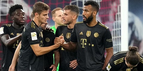 Bayern Munich's Eric Maxim Choupo-Moting, second right, is congratulated after scoring his sides fourth goal during the German Bundesliga match against RB Leipzig in Leipzig. (Photo | AP)