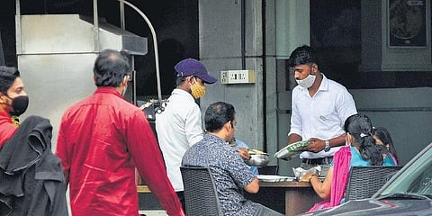 A restaurant at Palayam in Thiruvananthapuram serves customers through a temporary arrangement it made on its premises on Monday. | B P Deepu