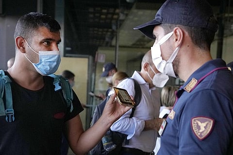 A police officer checks a passenger's phone at Porta Garibaldi train station, in Milan, Italy, Wednesday, Sept. 2, 2021. (Photo | AP)