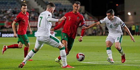 Portugal's Cristiano Ronaldo (C) runs with the ball during the World Cup 2022 group A qualifying soccer match between Portugal and the Republic of Ireland at the Algarve Stadium. (Photo | AP)