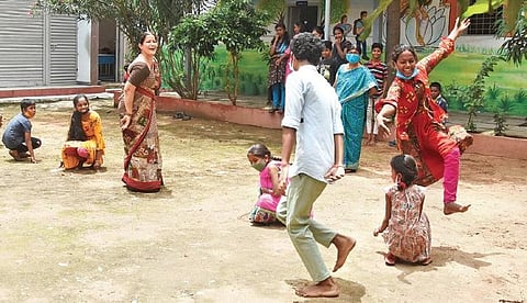 Students of Andhra Vidyalaya High School, Kattal Mandi play Kho kho along with their teacher during break on Wednesday. (Photo | R V K Rao)