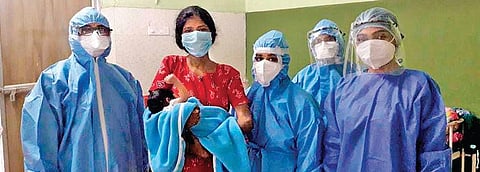 Gynaecology department staff with the baby of the 100th Covid-infected pregnant woman who delivered at Thrissur General Hospital. (Photo | EPS)