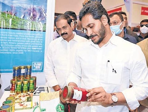 Chief Minister YS Jagan Mohan Reddy examines a product at a stall at Vanijya Utsavam 2021 in Vijayawada on Tuesday I Express
