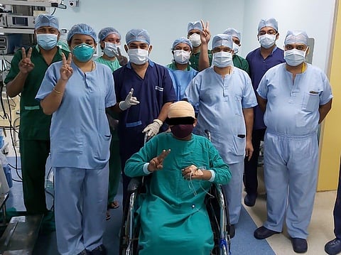 The surgeons with the patient after awake brain surgery.