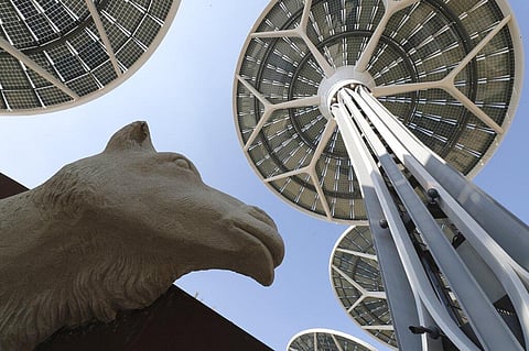 Energy trees are seen next to a camel sculpture at Terra, The Sustainability Pavilion during a media tour at the Dubai World Expo site. (Photo | AP)