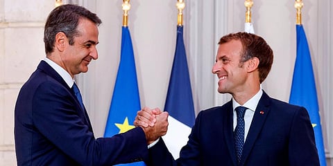 Greek Prime Minister Kyriakos Mitsotakis, left, and French President Emmanuel Macron shake hands after the signing of a new defense deal at The Elysee Palace, Sept. 28, 2021 in Paris. (Photo | AP)