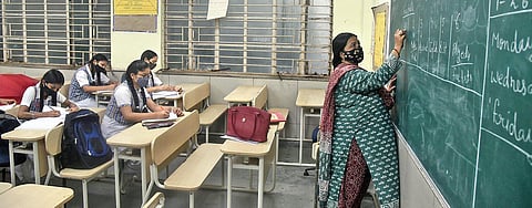 Students of Class XII at a Delhi government school in New Delhi on Wednesday. Though attendance is thin, Covid protocol is being followed. (Photo | Parveen Negi, EPS)