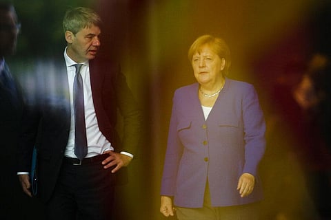German Chancellor Angela Merkel, right, talks to then foreign policy advisor Jan Hecker (Photo | AP)