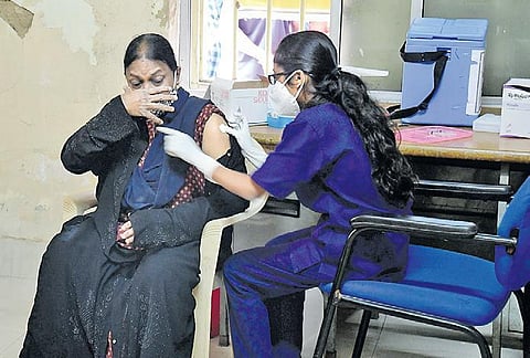 A health worker administers Covid-19 vaccine to a beneficiary at a health centre in Bengaluru. (Photo | Shriram BN, EPS)