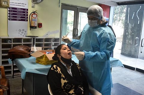 A health worker takes swab sample for COVID-19 test, amid concern over rising Omicron cases (File photo| Shekhar Yadav/EPS)