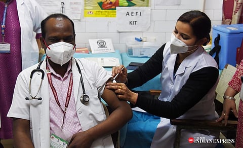 A health worker administers a booster dose of COVID-19 vaccine to a beneficiary in New Delhi on Monday. (Photo | Shekhar Yadav, EPS)
