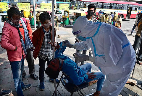 Health worker collects swab sample of a person in Bengaluru. (Photo | Shriram BN, EPS)