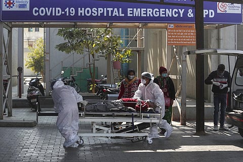 Health workers shift a patient on a stretcher at a COVID-19 hospital in Ahmedabad, India, Wednesday, Jan. 12, 2022. (Photo | AP)