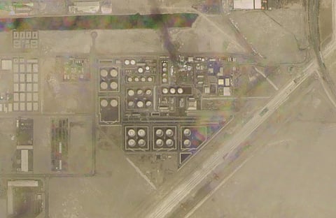 In this satellite image provided by Planet Labs PBC, smoke rises over an Abu Dhabi National Oil Co. fuel depot in the Mussafah neighborhood of Abu Dhabi, United Arab Emirates, Jan 17, 2022. (AP)