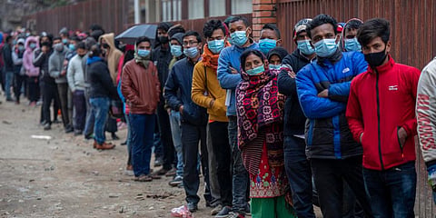 Nepalese people queue up to get vaccinated after government made vaccination cards mandatory for people to access public services in Kathmandu. (Photo | AP)
