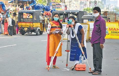 VMC engineering staff take measurements for construction of an underground drainage, in Vijayawada on Friday | Prasant Madugula
