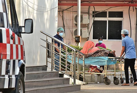Hospital employees shift a patient to the COVID triage centre. (File Photo)