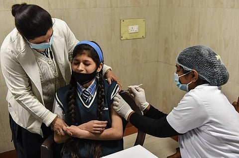 A health worker administers a COVID-19 vaccine to a teenager at SPM Hospital, in Lucknow, Monday, Jan. 3, 2022. (Photo | PTI)