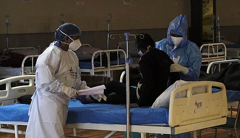 Medics attend to a patient at the Covid Care Centre of Shehnai Banquet hall, in New Delhi. (Photo | Shekhar Yadav, EPS)