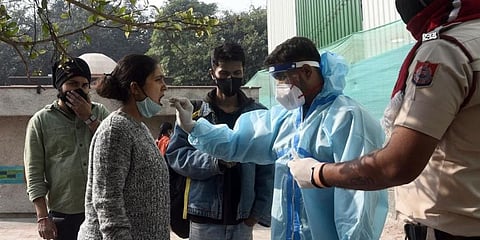 A health worker takes a swab sample for COVID-19 test in New Delhi on Saturday. (Representational photo | Parveen Negi, EPS)