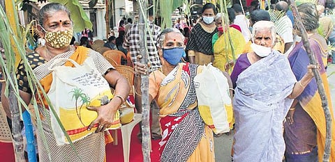 Beneficiaries display the items they got as part of the Pongal gift hamper during an event in Coimbatore on Tuesday | U RAKESH KUMAR