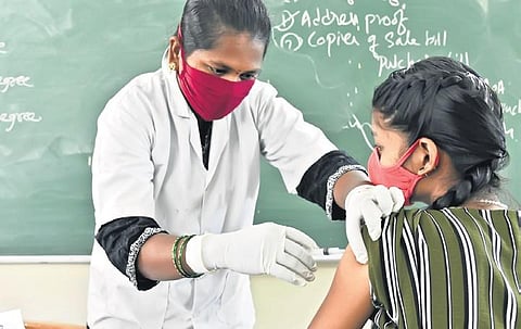 a health worker administers Covid vaccine to a girl on Friday | vinay Madapu