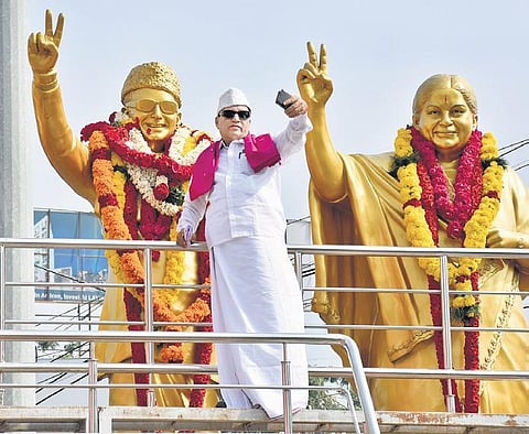 In this file image, a fan poses for a selfie standing beside a statue of MGR. The former CM still remains popular among fans and political cadre in the State.