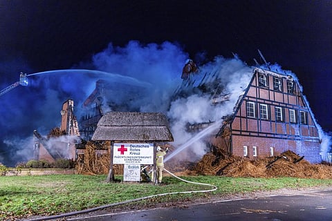 Firefighters extinguish the fire in a hotel where refugees from Ukraine were accommodated in Gross Stroemkendorf, Germany, Thursday, Oct.20, 2022. (Photo | AP)