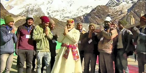 Prime Minister Narendra Modi interacts with workers engaged in development project at the Kedarnath holy site, in Rudraprayag district. (Photo | PTI)