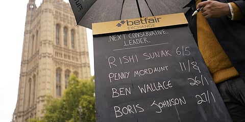 A bookmaker takes bets for the next British Prime Minister after Liz Truss resigned in London, Thursday, Oct. 20, 2022. (Photo | AP)