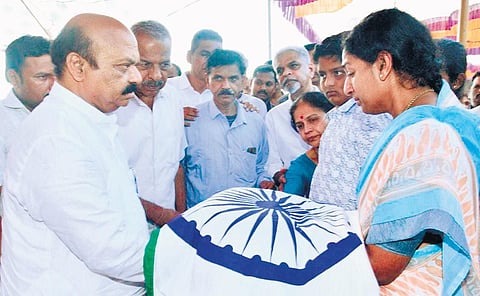 (Left) A large gathering during the funeral of Anand Mamani at Saundatti on Sunday; CM Basavaraj Bommai hands over the National Flag to Mamani’s wife