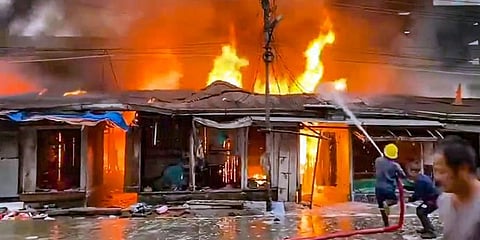 Firefighters attempt to douse a fire that broke out at shops in Naharlagun Daily Market, near Itanagar, Tuesday, Oct. 25, 2022. (Photo | PTI)