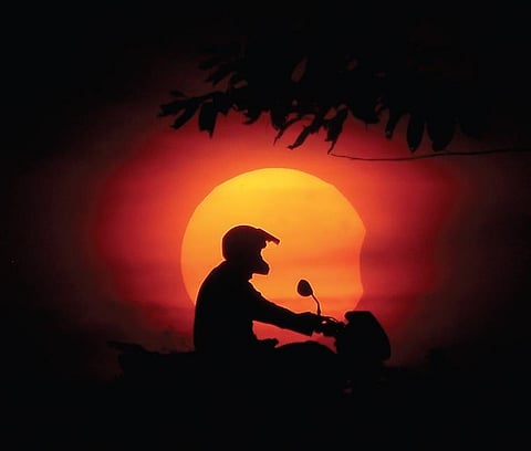 A man pictured against the solar eclipse, on the outskirts of Bhubaneswar, on Tuesday | DEBADATTA MALLICK