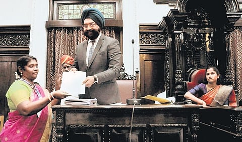 Corporation commissioner Gagandeep Singh Bedi handing over a certificate to councillor P Amudha for being elected to the syndicate of Madras University, on Friday | Express