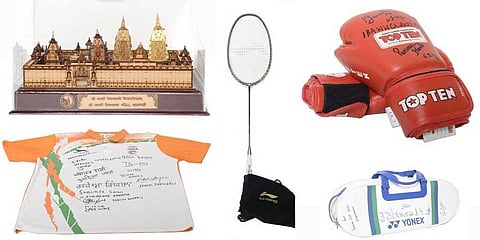High bids for sporting gear, replicas gifted to PM