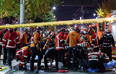 Rescue workers and firefighters work on the scene of a crushing accident in Seoul, South Korea, Saturday, Oct. 29, 2022. (Photo | AP)