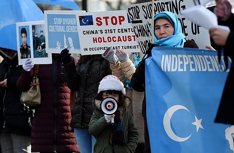 In this file image, protesters hold a demonstration against the human rights violation of Muslims in China's Xinjiang. (Photo| AFP)