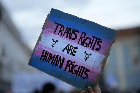 A demonstrator holds up a sign during a march to mark International Transgender Day of Visibility in Lisbon, March 31, 2022. (Photo | AP)