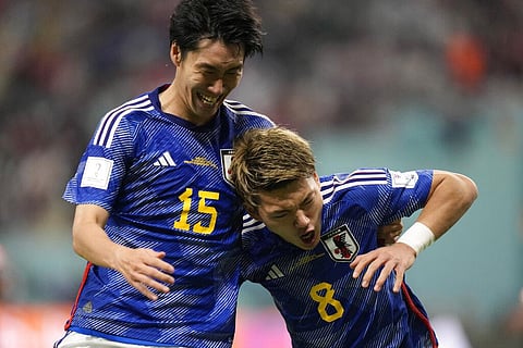 Japan's Ritsu Doan, right, celebrates after scoring his side's opening goal during the World Cup group E soccer match between Germany and Japan, at the Khalifa International Stadium. (Photo | AP)