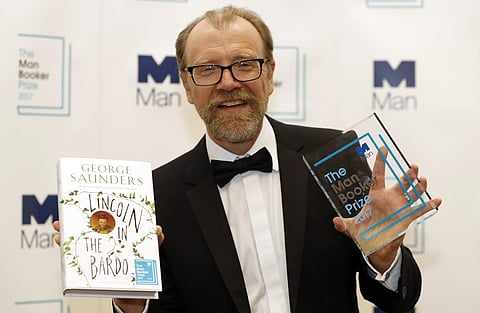 In this backdated image, George Saunders with his book 'Lincoln in the Bardo' during a photocall after being announced winner of the 2017 Man Booker Prize, in London. (Photo |AP)