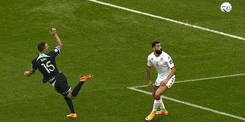 Australia's Mitchell Duke, (L), scores his first side goal as Tunisia's Yassine Meriah looks on during the World Cup group D match at the Al Janoub Stadium in Al Wakrah, Nov. 26, 2022. (Photo | AP)