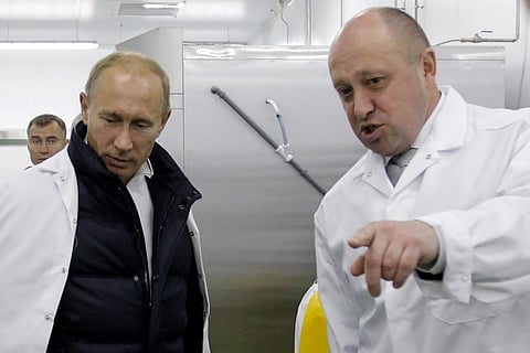 Businessman Yevgeny Prigozhin,(R), with Russian President Vladimir Putin at a factory in Saint Petersburg. (Photo | AFP)