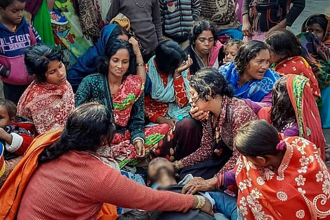 Family members and relatives of people, who died after consuming allegedly spurious liquor mourn near their mortal remains, at Ishuapur police station area in Bihar's Saran district. (Photo | PTI)