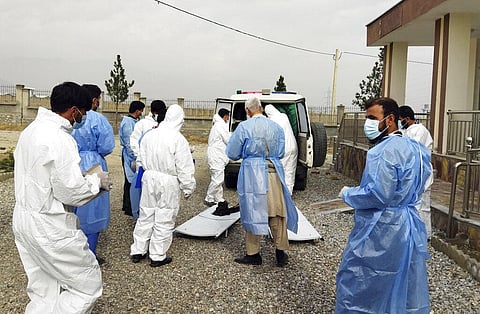 Doctors collect the bodies of victims in a fuel tanker explosion in the Salang Tunnel through the Hindu Kush mountains, north of Kabul, Afghanistan on Dec. 18, 2022 | AP