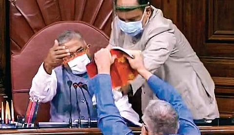 Trinamool Congress MP Derek O’Brien shows the rule book to Rajya Sabha dy chairman Harivansh Narayan Singh in the Parliament House on Sunday | PTI
