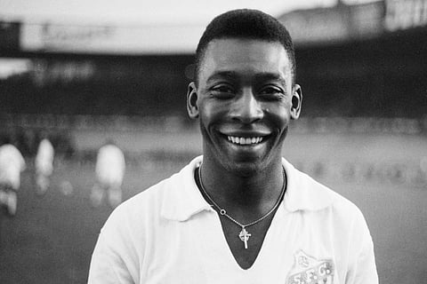 Brazilian striker Pele, wearing his Santos jersey, smiles before playing a football match with his club against the French club of 'Racing', at the Parc des Princes, in Paris.( File | AFP)