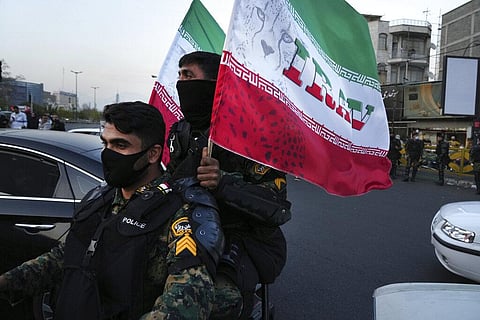 Anti-riot police officers carry representations of the Iranian flag. Image used for representational purpose.